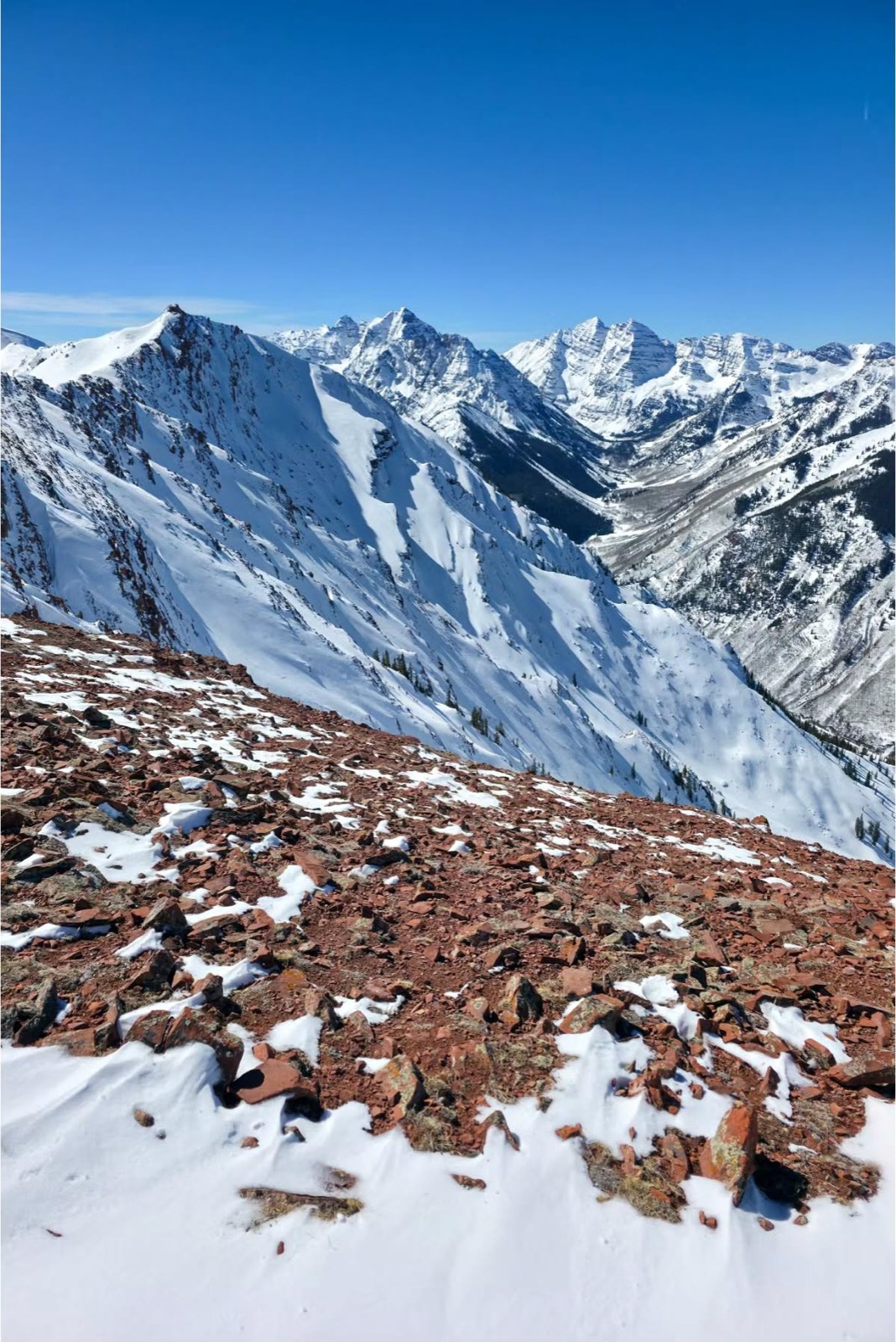 Skiers hiking the ridge of Highlands Bowl above Aspen