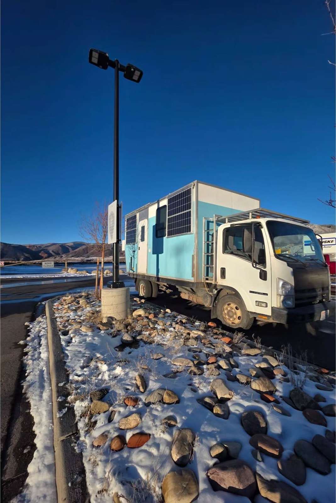 The truck parked in deep winter snow